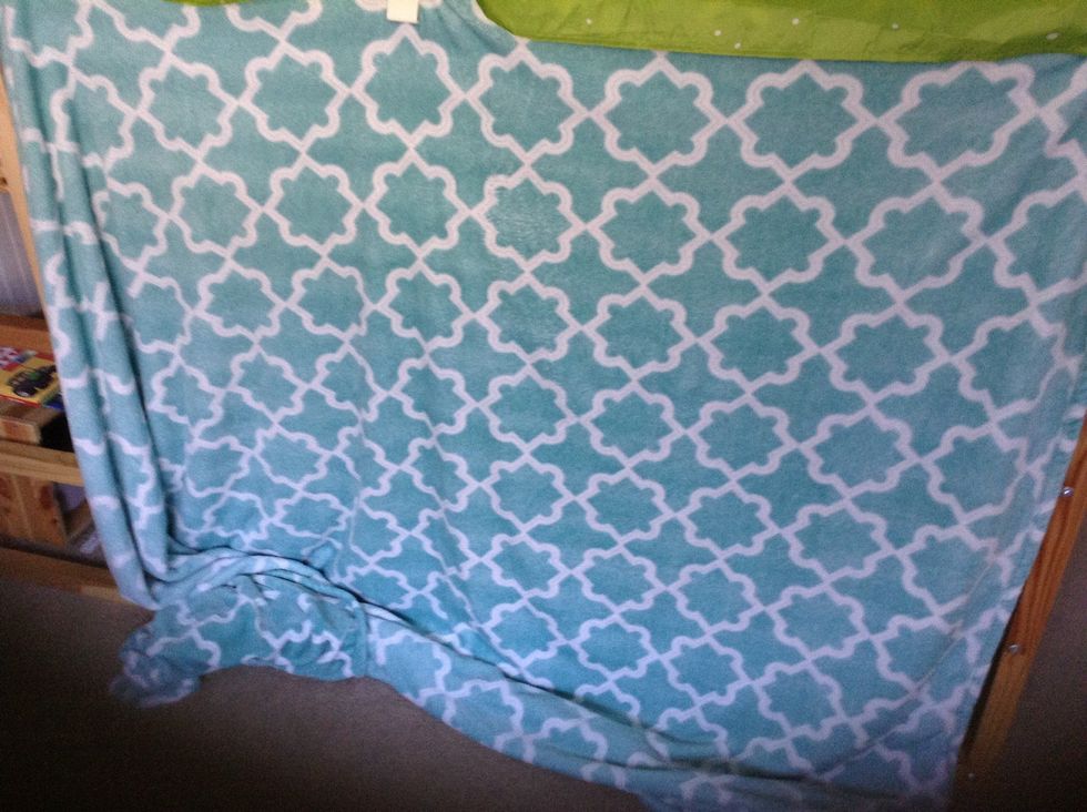 First we added a blanket on the bottom part just hanging off the top