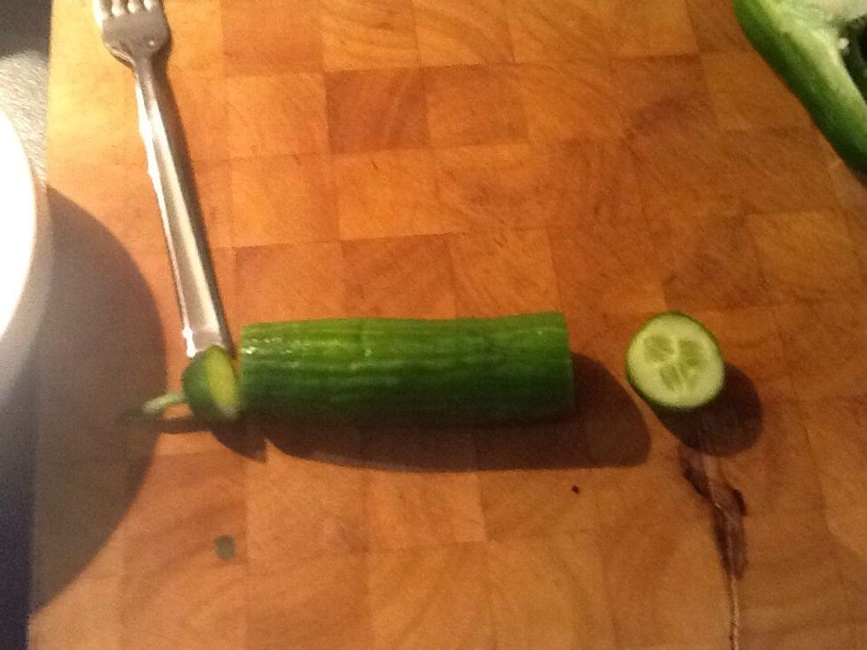 First we cut the ends of the cucumber. (Like so)