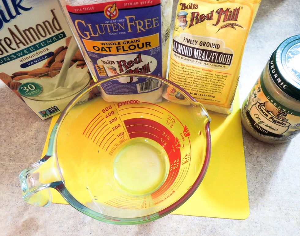 First we'll make the crust. Get tahini, oat flour, almond meal and almond milk ready. (and small aluminum foil pie pan that is sold in every store, we'll pack the crust into it)