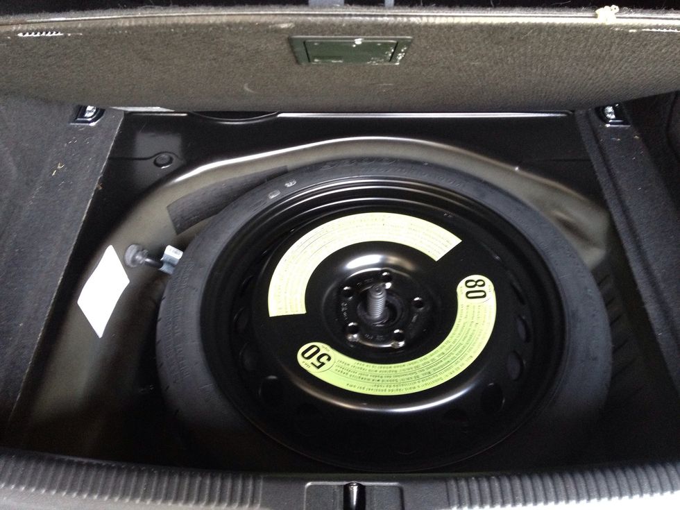 First we need to get into our trunk toolkit to get the tools we need (thank you Audi for supplying these!). Remove the spare tire to get to the kit.