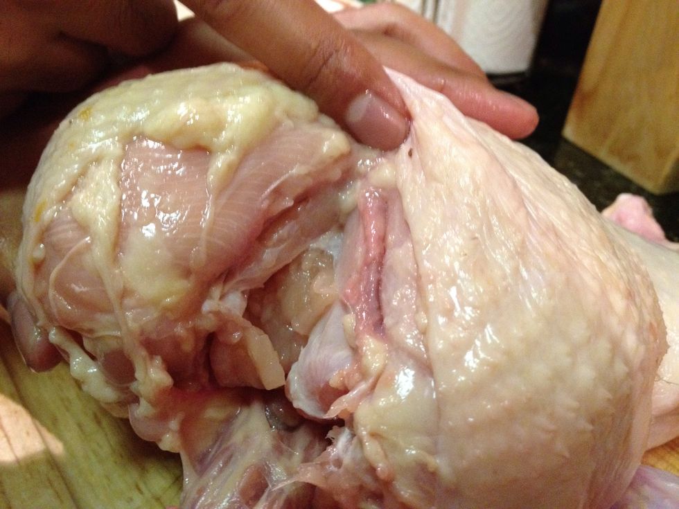 First we need to locate the wishbone. Removing the wishbone will allow you to carve the chicken easier after roasting.