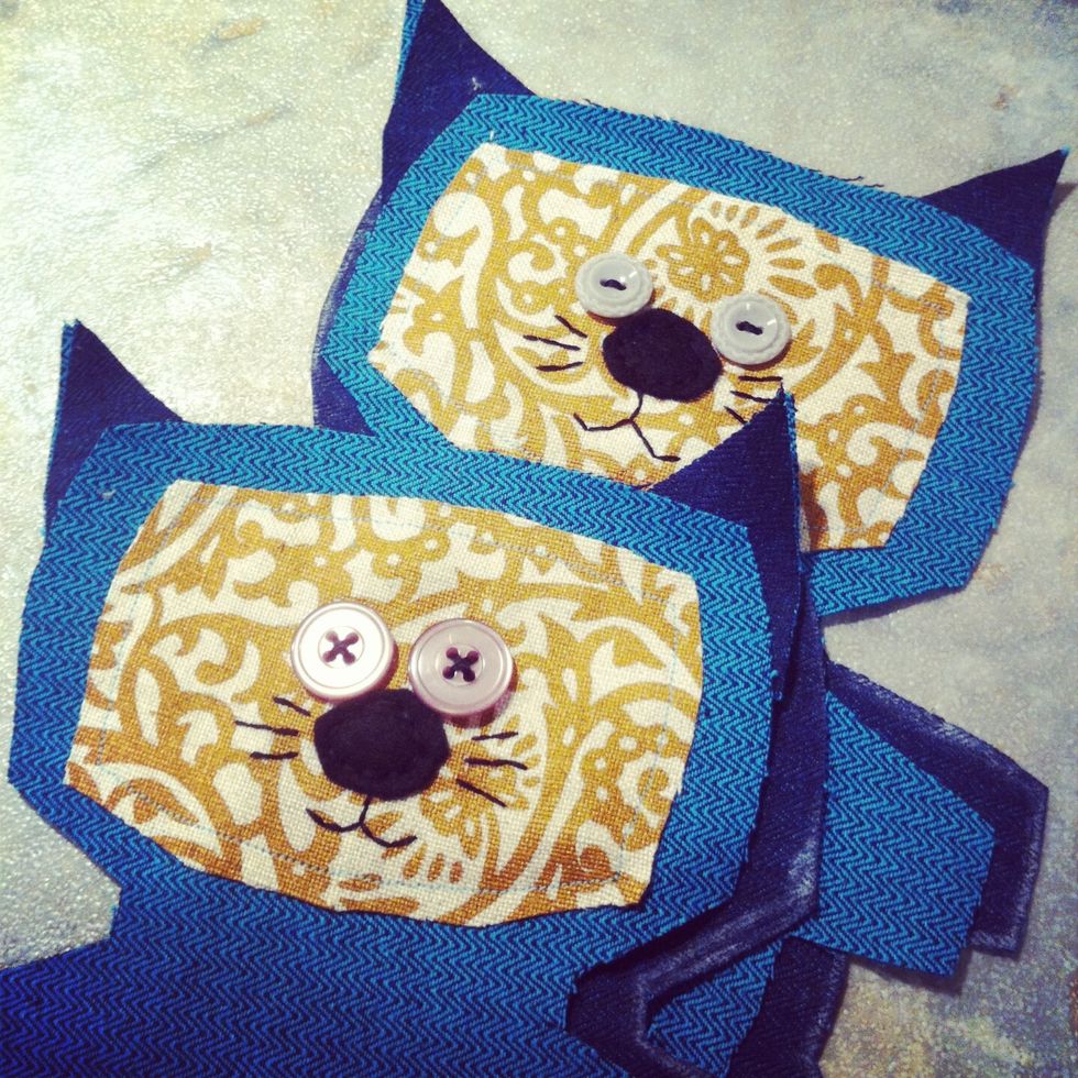 First work on the face using buttons, felt & fabric accents. You can do all of the stitching by hand. I used my sewing machine for the patterned fabric.