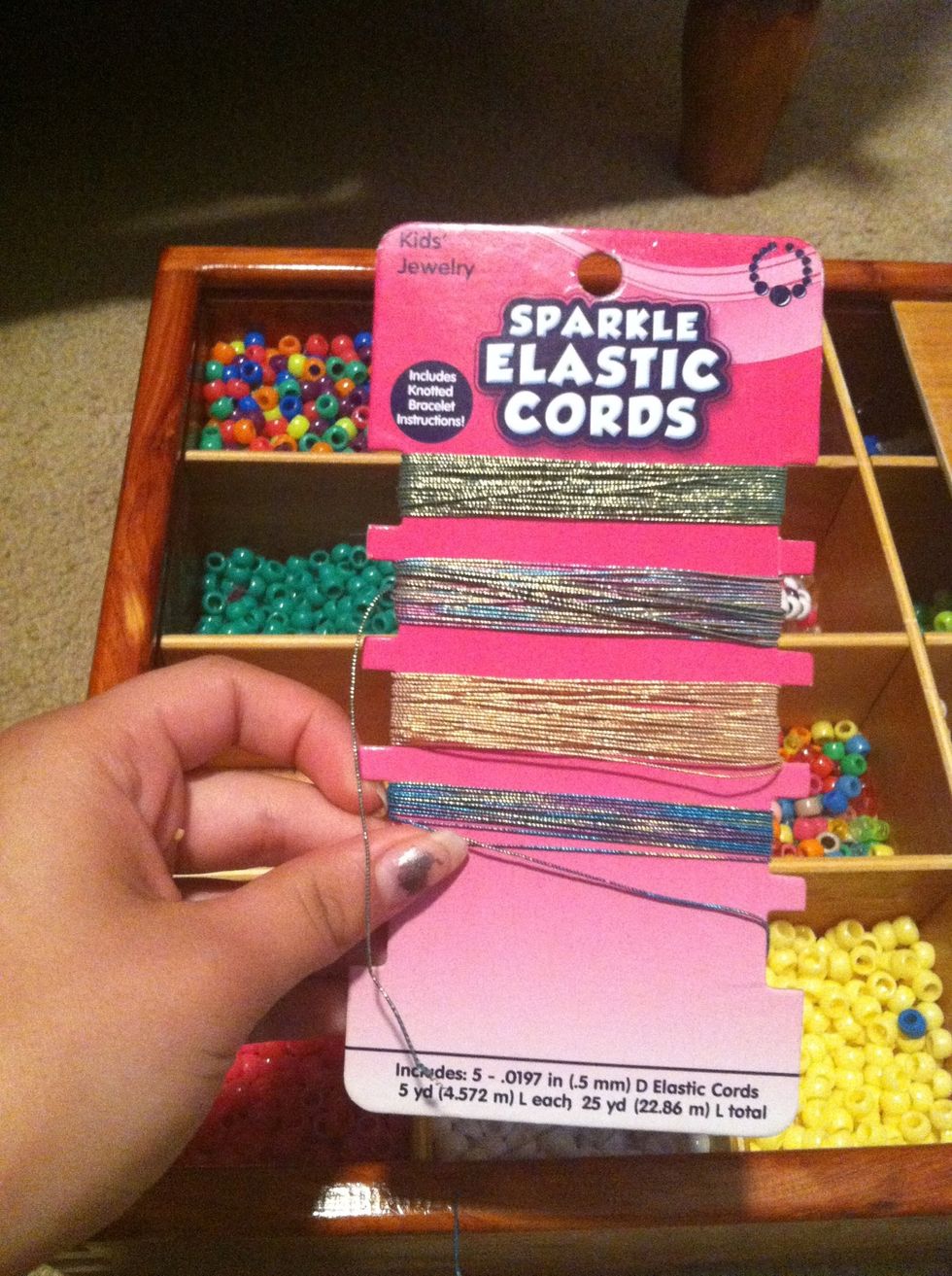 First you are going to get any type of string from the bead aisle at Walmart, I chose sparkle elastic cords.