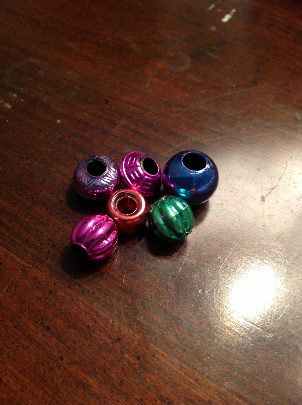 First you are going to need some beads, feathers, bells, etc. No glass beads for safety reasons. As long as they're plastic, they can be whatever size/shape/color you want! I got mine from Michael's.