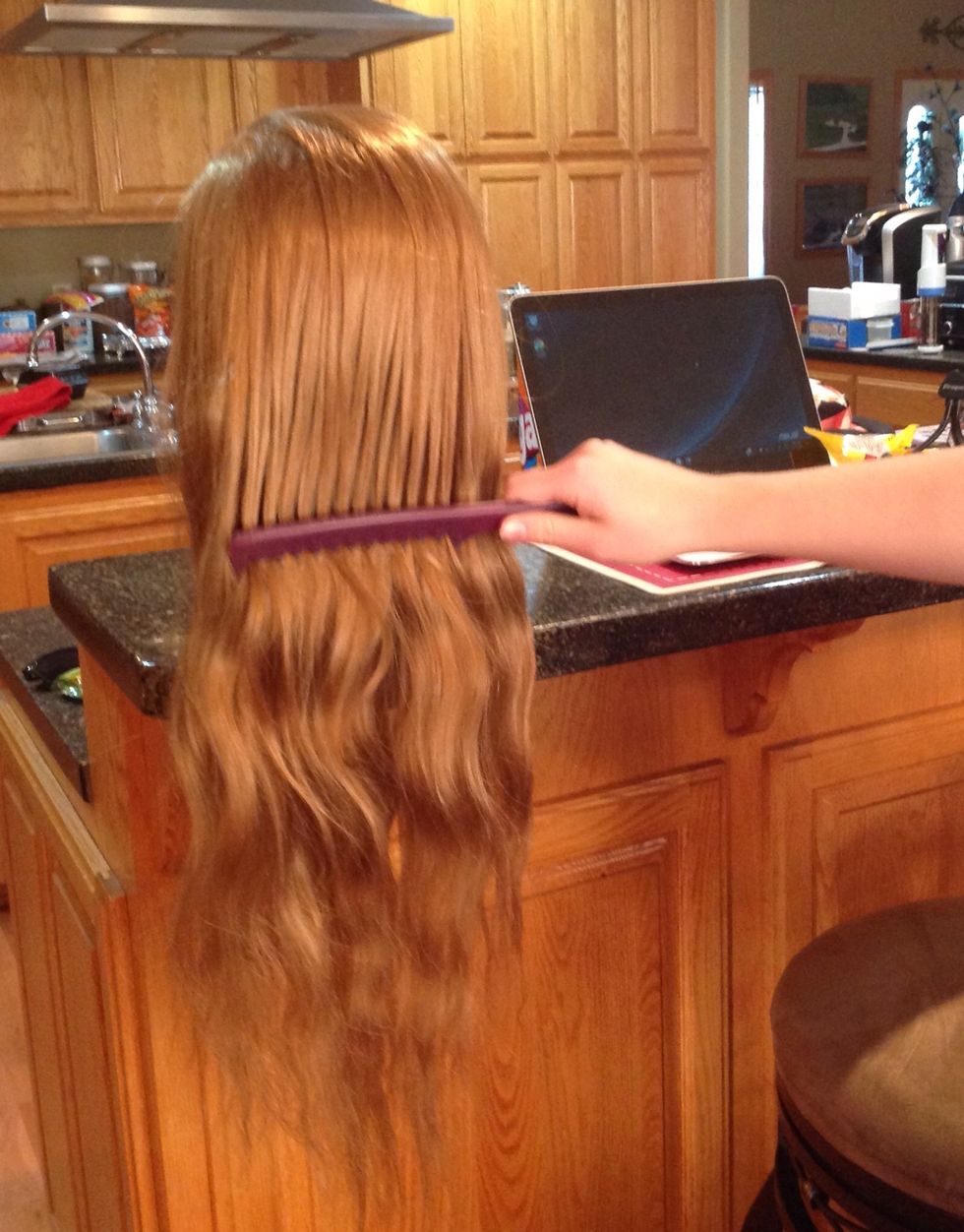 First you comb through the hair to remove any tangles.