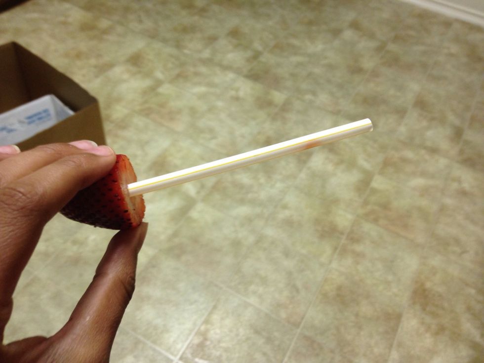 First, you cut off the top of the strawberry with your knife and insert your straw. That little piece that becomes separated from the inside, scoop it out or sip it through your straw.