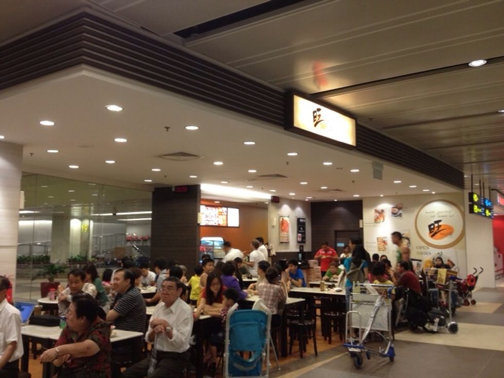 First, you have to locate yourself. Assuming you are arriving at Terminal 1, you will find this \u65fa (Wang) food stall, which serves a variety of local dishes, near your belt exit. This is Basement 1