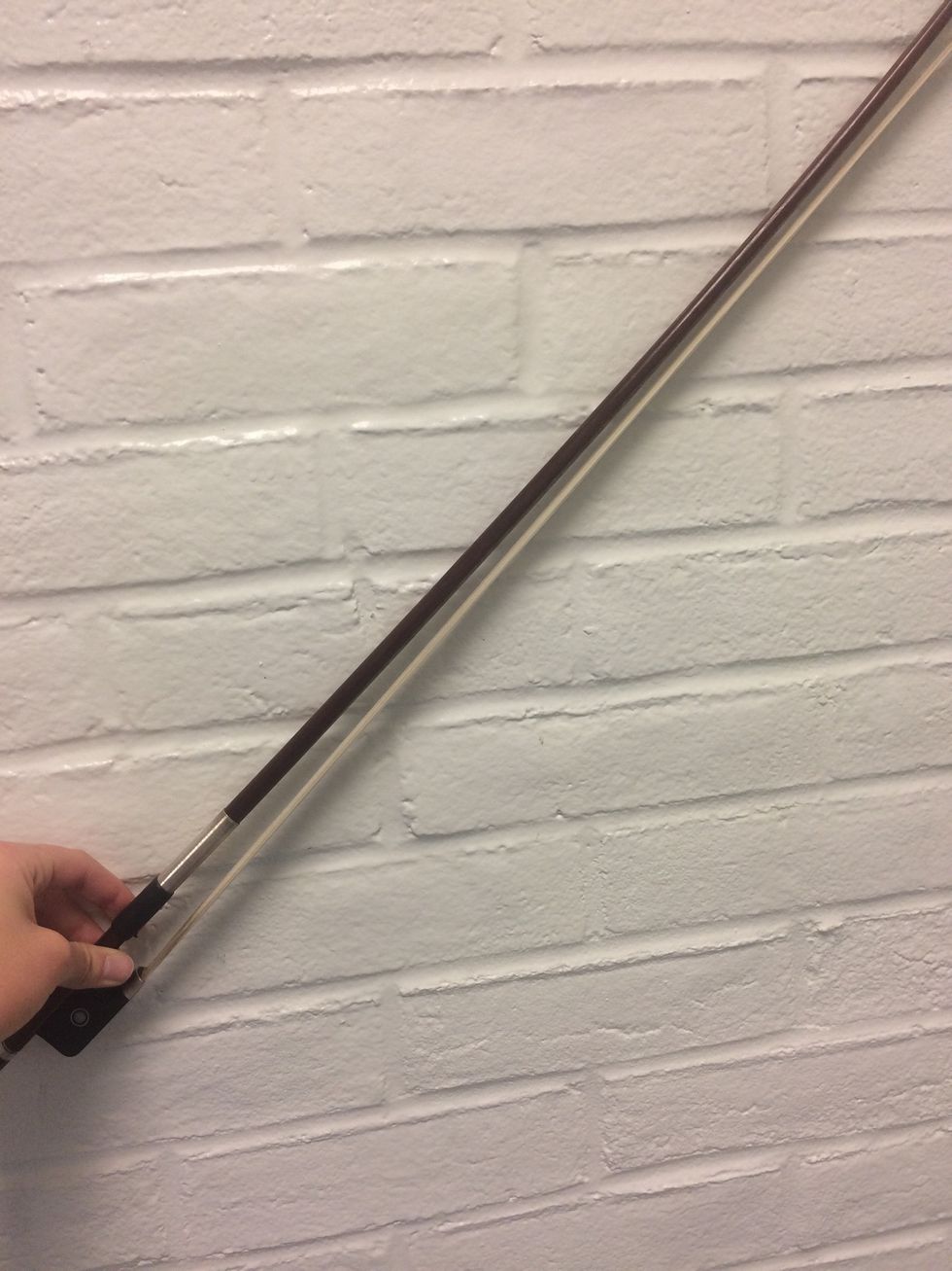 First, you must tighten the bow. Turn the screw in the very bottom clockwise until the wood of the bow is slightly curved. This is a loosened bow.