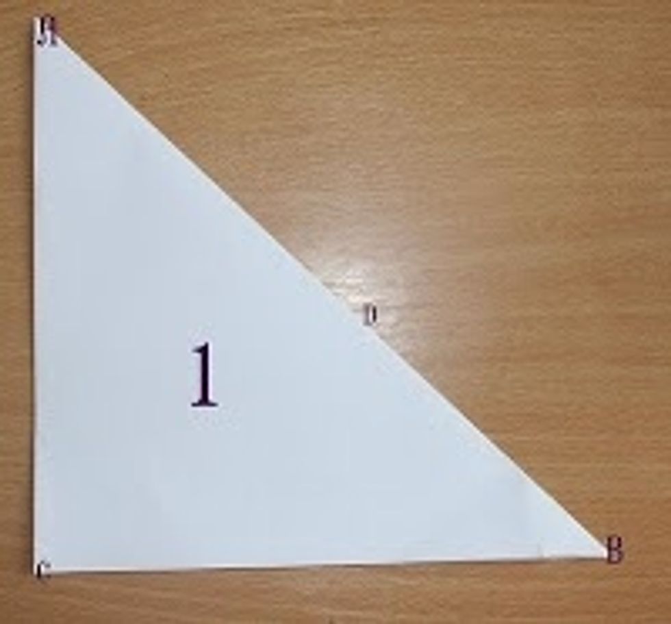 First, you need a square of paper and fold it downwards on the diagonal