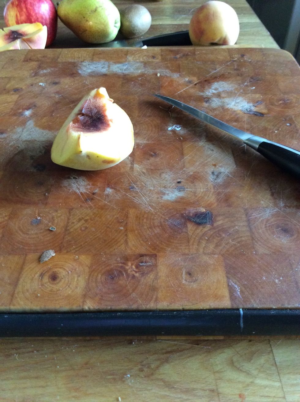 First, you need to cut your peach in half with your knife .