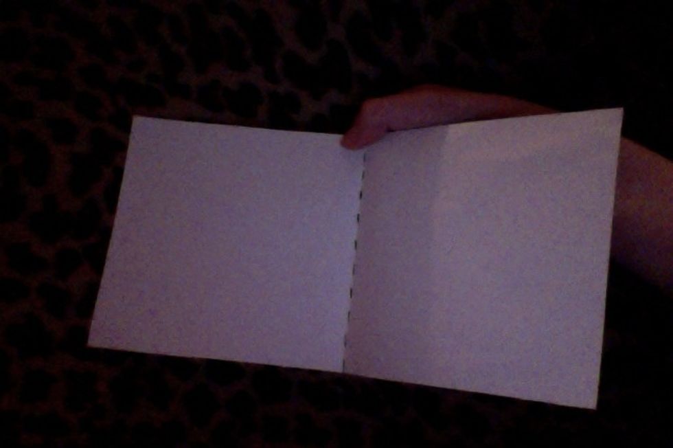 First, you need to fold the paper widthwise, to make a crease, then unfold the paper.