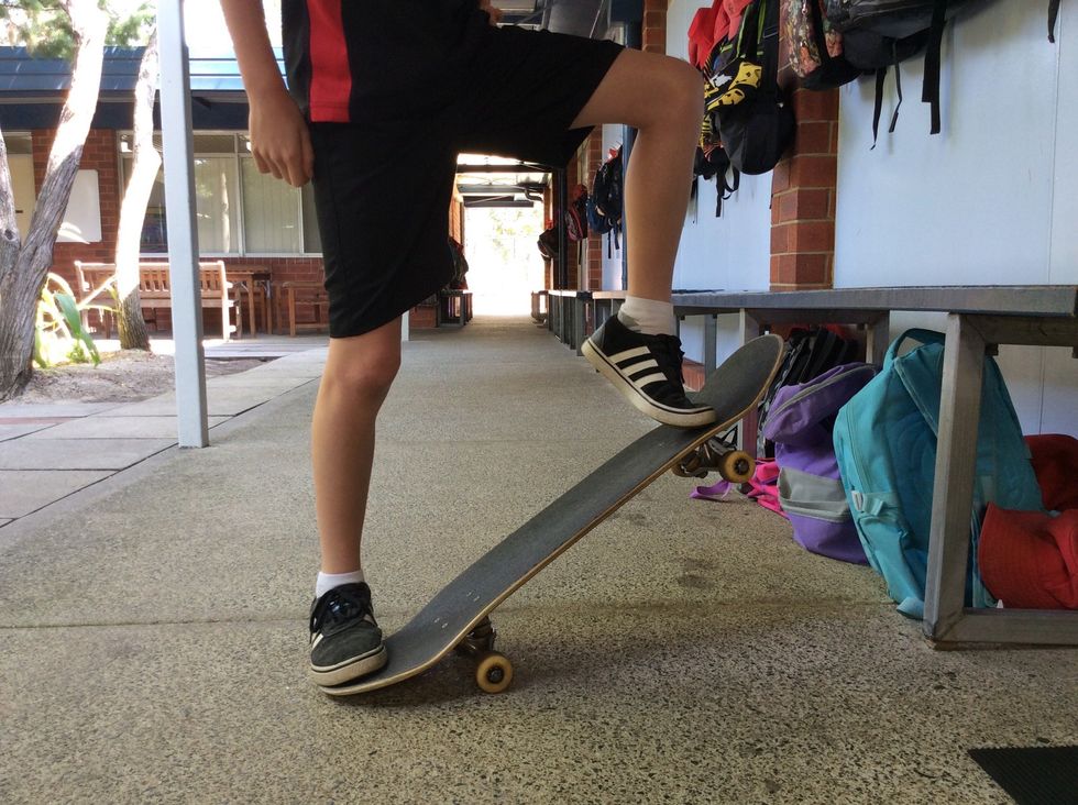 First you need to pop the back tail to the ground and then slide your foot up to the top. Hopefully your in the air if you are push your front foot out more so the board goes straight.