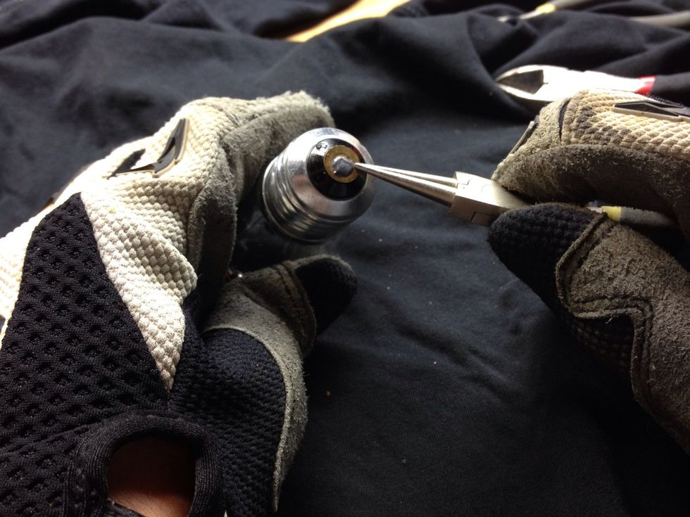 First you need to pry the metal circle that I'm pointing to off. The next step shows the process in a video.