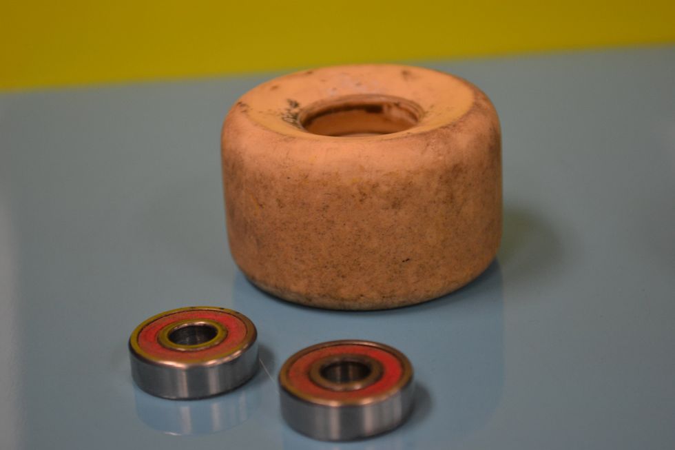 First you need to put the bearings into the wheels.