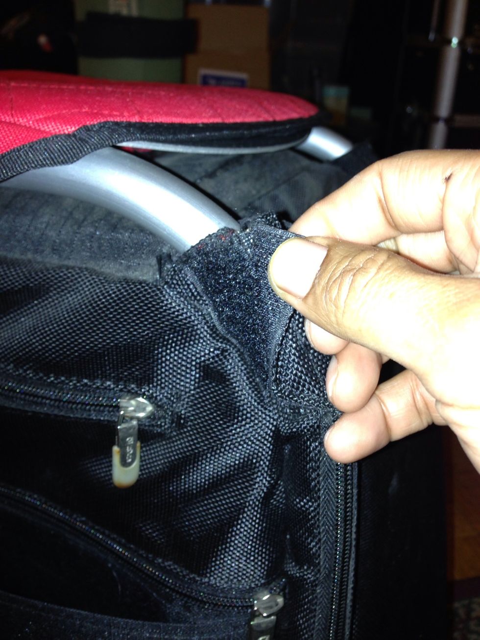 First you need to unzip the bag from the frame in order to gain access to the inner wheel housing. There are 2 Velcro attachments that cover the zipper, this one is at the top...
