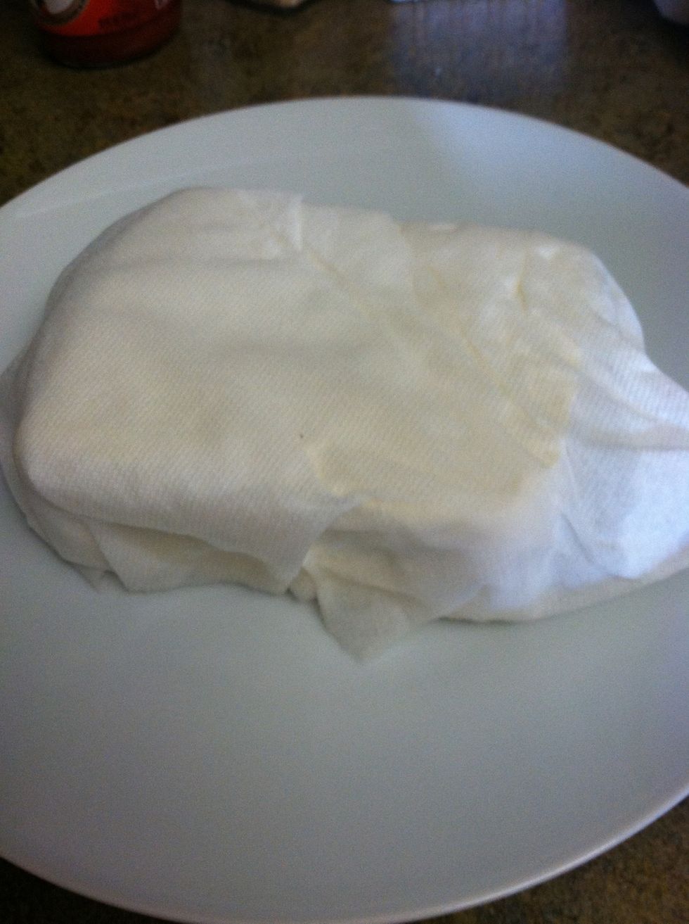 First you "press" the tofu. I wrap it in paper towels to absorb the extra liquid.
