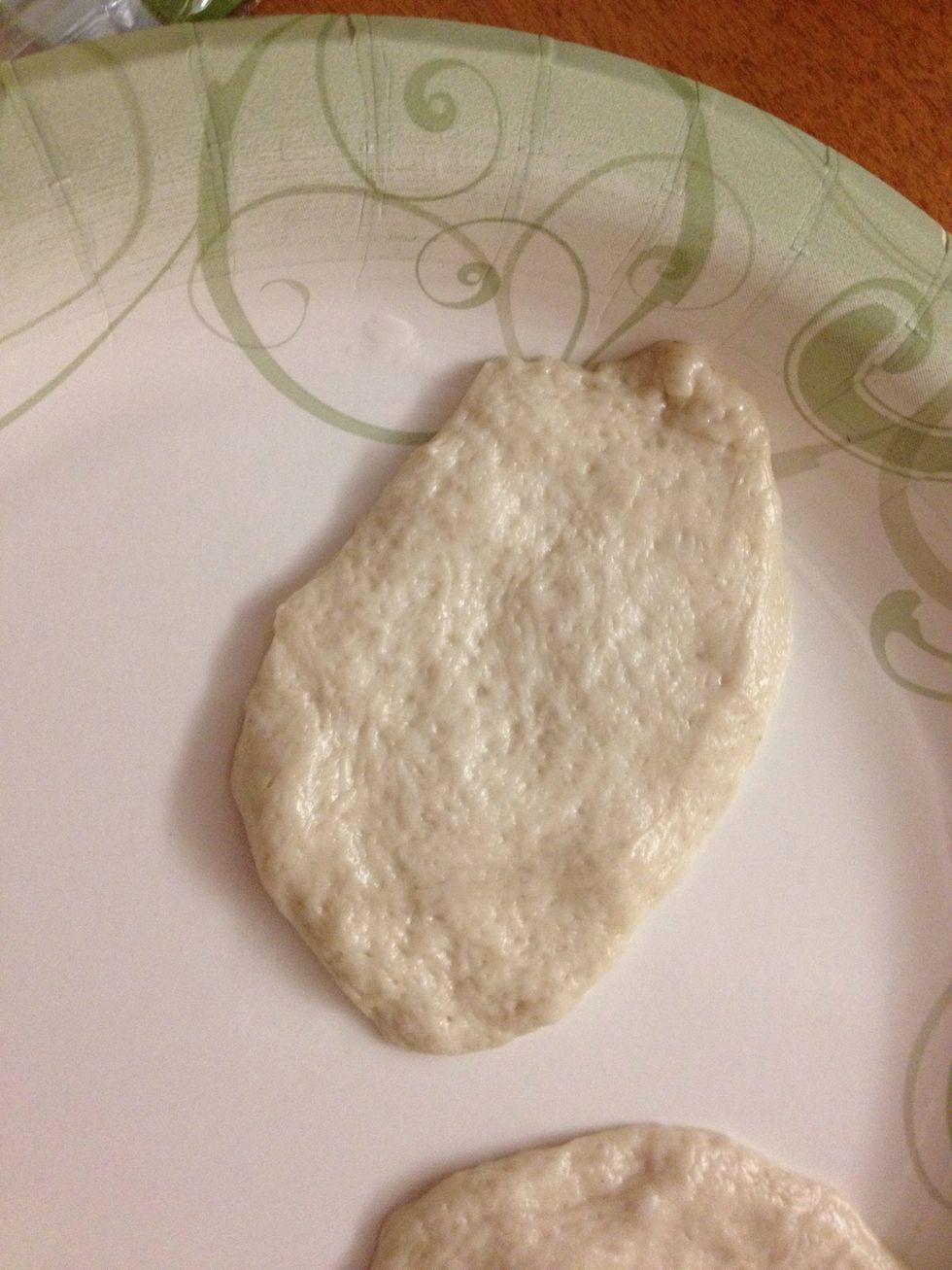 First you take out each biscuit roll and flatten them out.