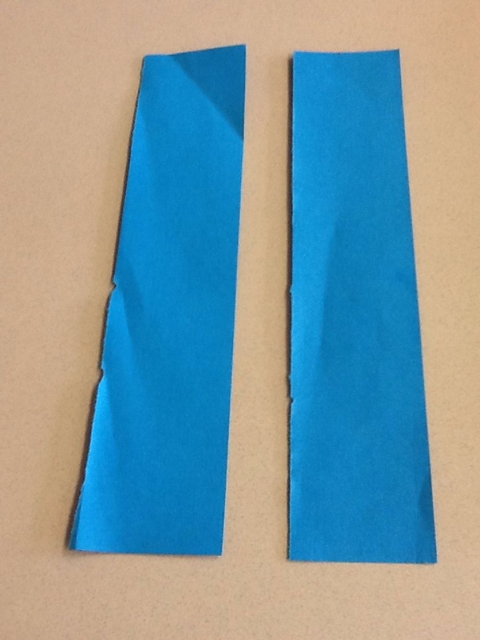 First you will need two skinny (about an inch wide) but long strips of paper.