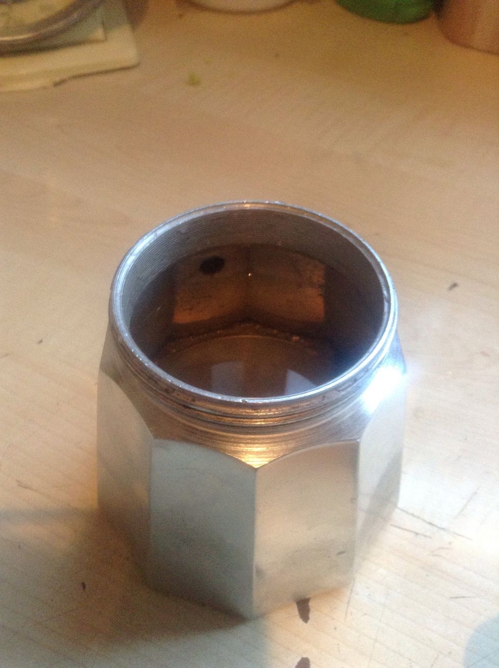 Firstly,fill the bottom chamber with freshly drawn water, whilst doing so make sure that the water is below the safety valve (the black spot in the chamber on the photo). Wash this before filling it.