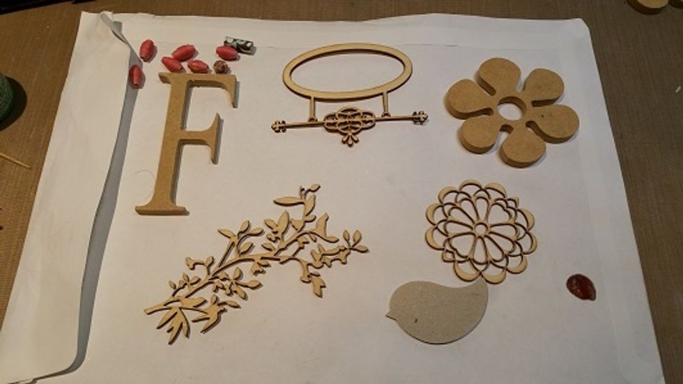 Firstly find the items you wish to decorate. I used a number of wooden laser cuts and also some paper beads and chipboard embellishments.