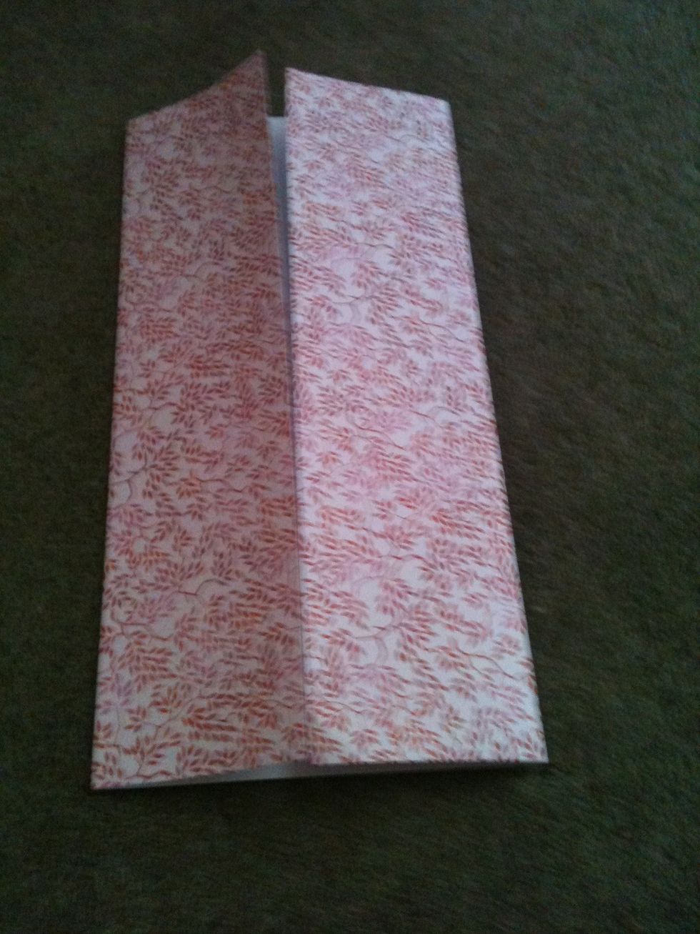 Firstly fold both sides of the paper inwards make a 1cm overlap