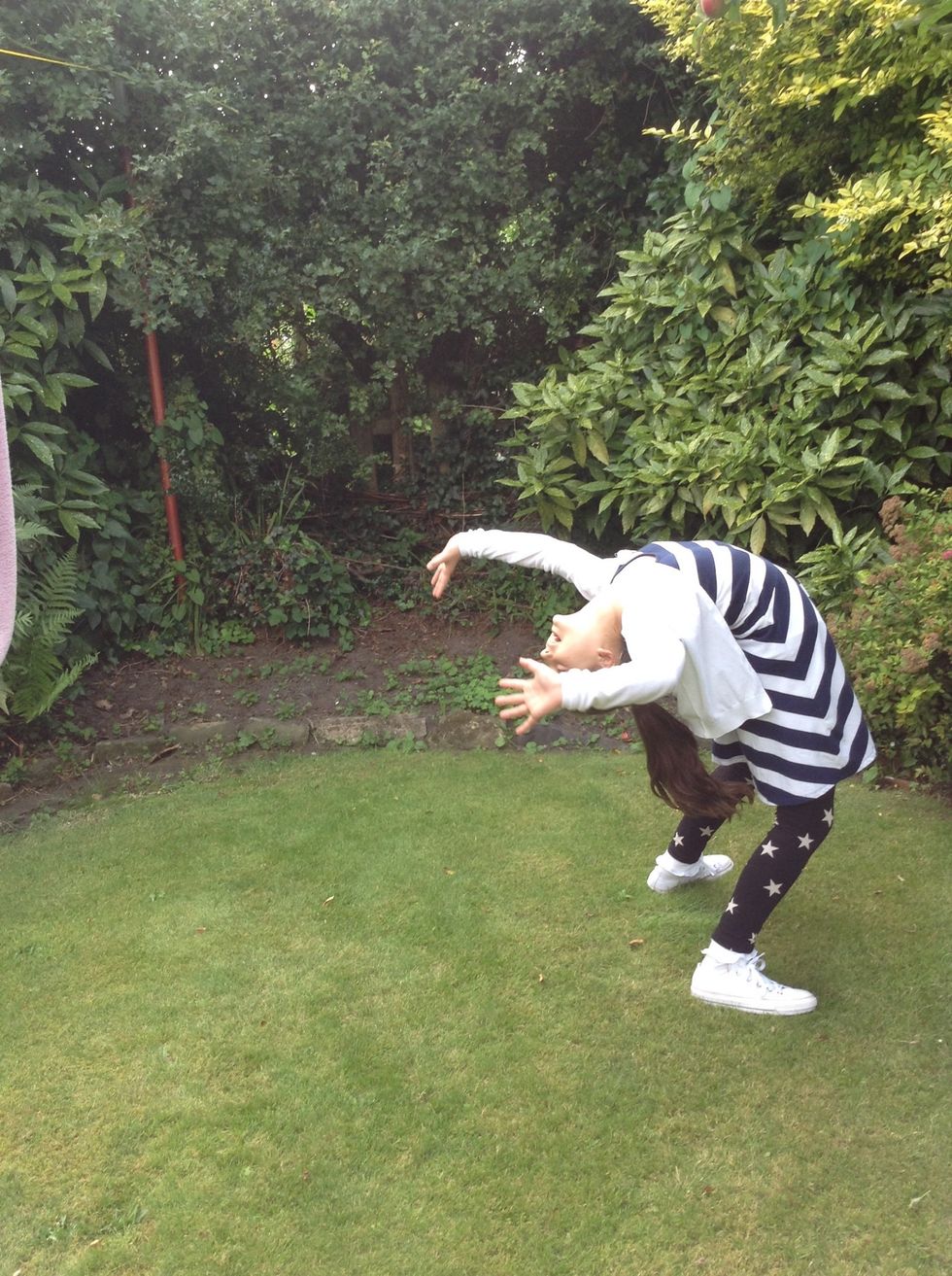 Firstly put your arms back and slowly lean back until you can't go any further. Once you've practiced this a few times you might be able to do this .....