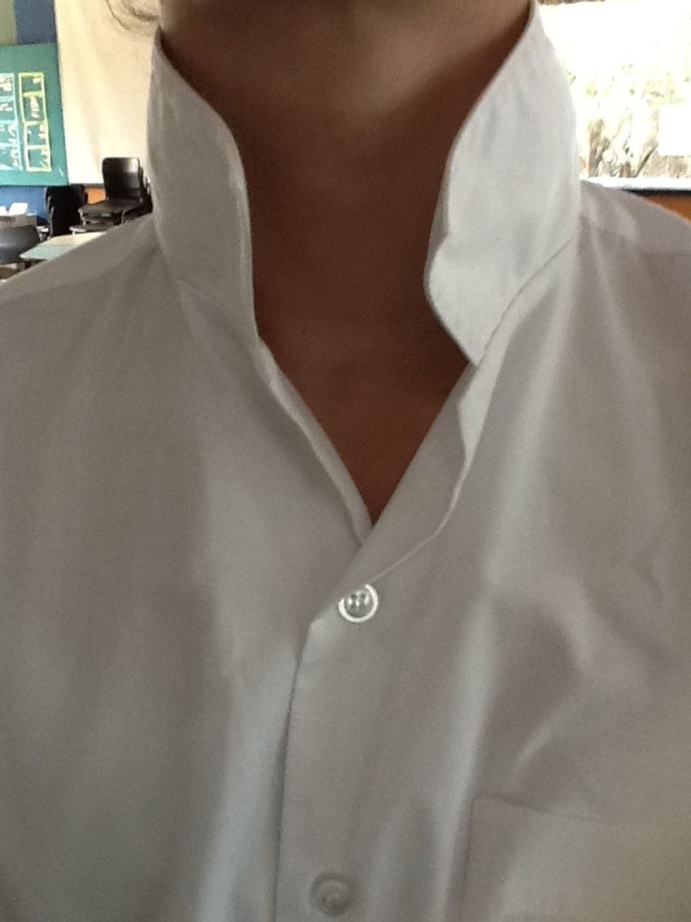 Firstly, put your collar up so it will be easier to place the tie around your neck.