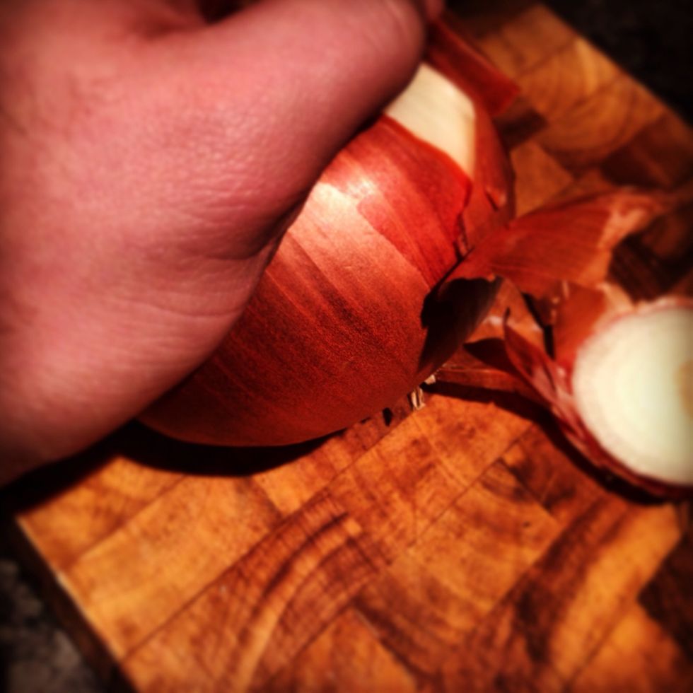 Firstly start by nipping the end off of the onions and peeling them whole.