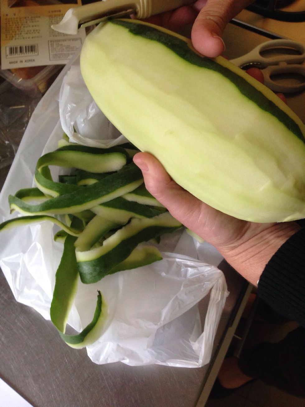 Firstly you need to peel the green papaya. You can do this with either a knife or a normal peeler you use for potatoes or carrots.