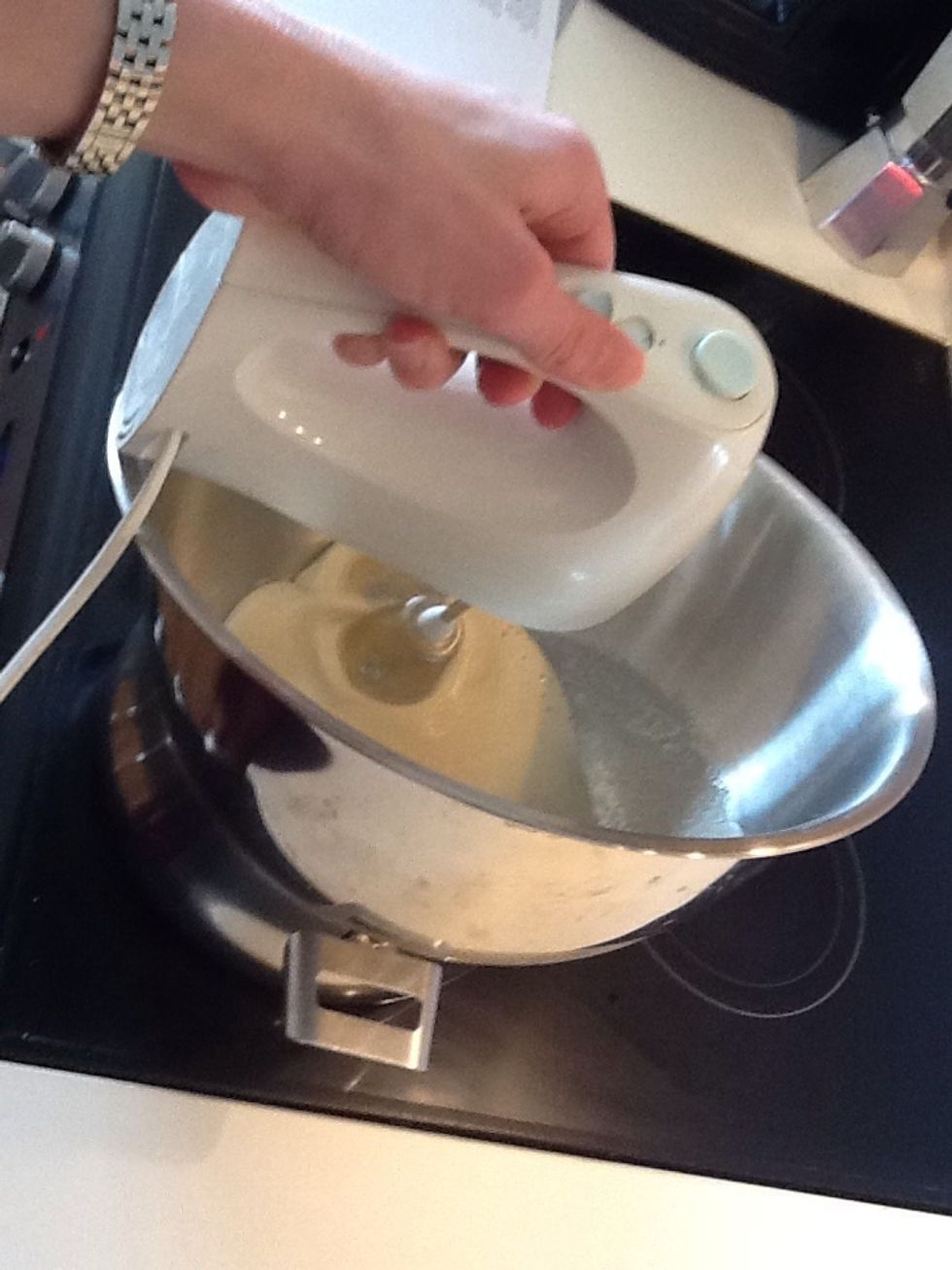 Fit a bowl over a saucepan of barely simmering water and put in all the icing ingredients except the vanilla and sprinkles. Whisk with an electric whisk for about 5 minutes.