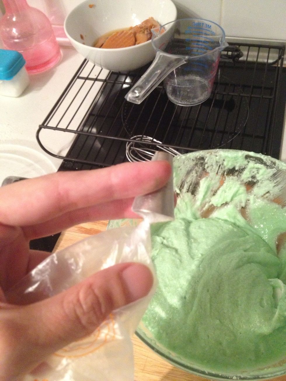 Fit it in ur piping bag and twist a lil before filling.