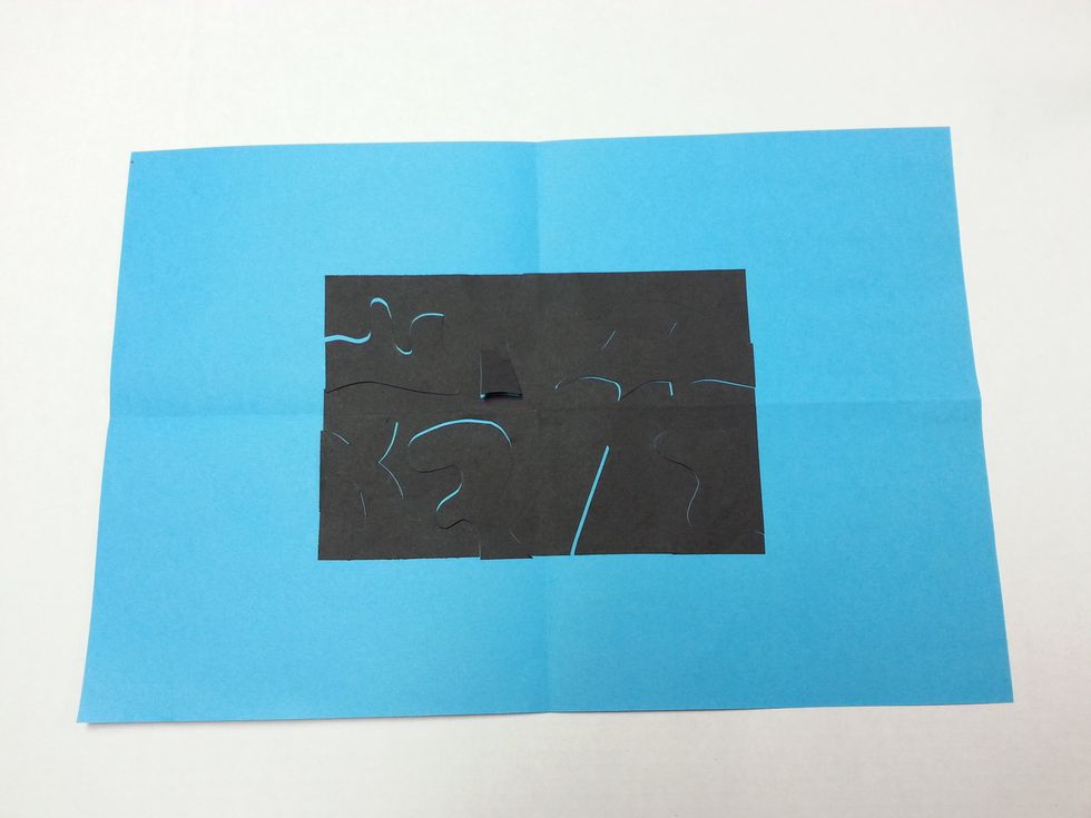 Fit the cut-out shapes back into their original places like a puzzle. Don't glue yet!