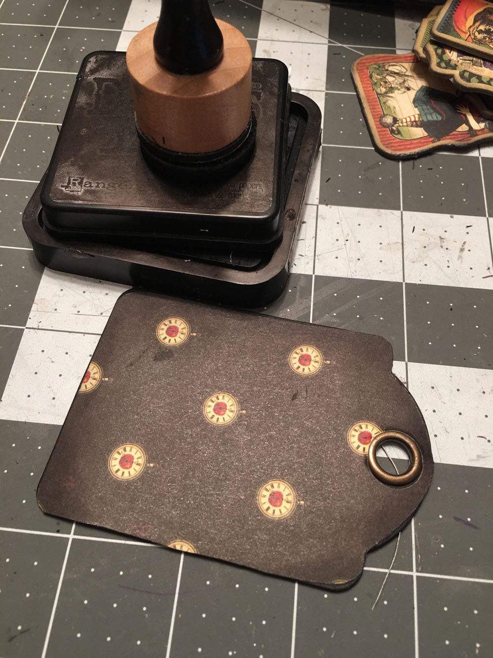 Fit the patterned paper you cut out with the punched hole over the ATC tag and glue down. Ink the edges. Repeat for all the ATC tags for the album. And use the same method for the back of each tag.