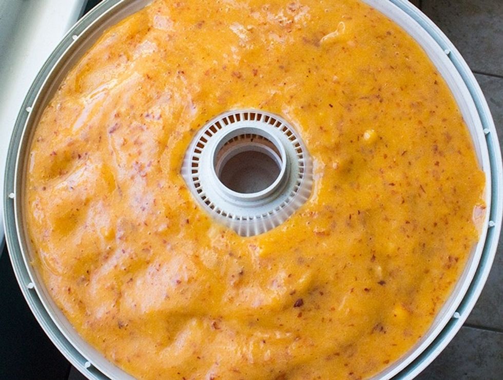 Five peaches makes enough for two trays worth of mix, so just divide it up. Use a spatula, or lightly rap the tray on the counter to evenly spread the mix.