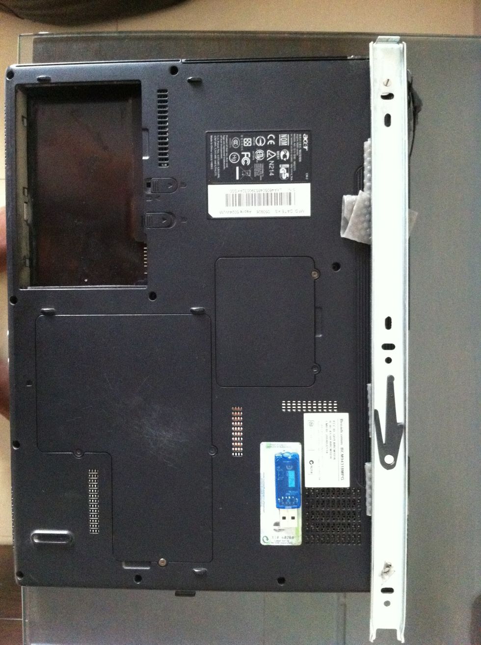 Fix one part of the sliding channel on to the laptop with screws