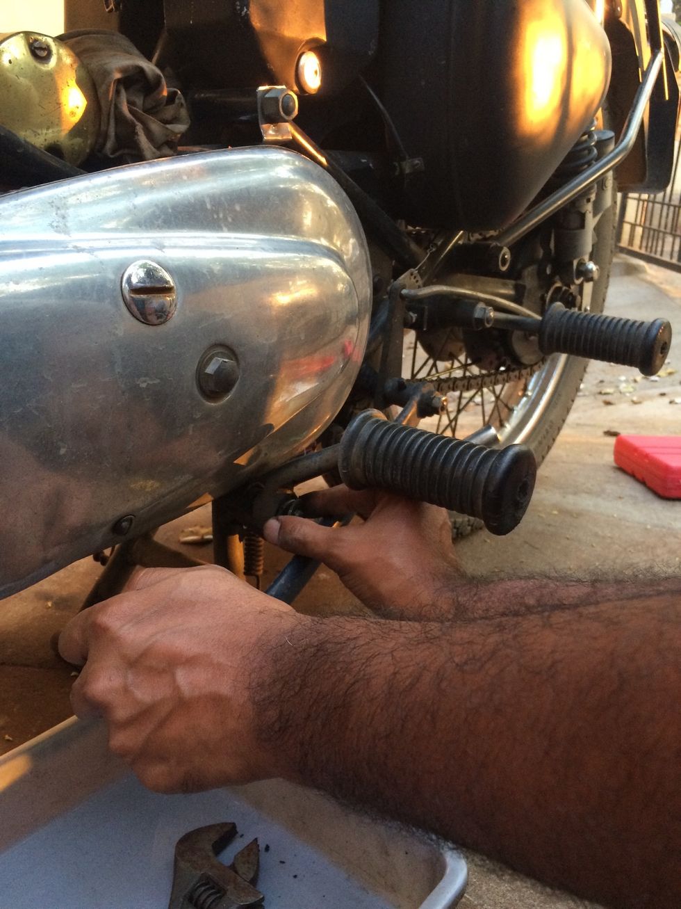 Fix the footrest back and tighten the nut