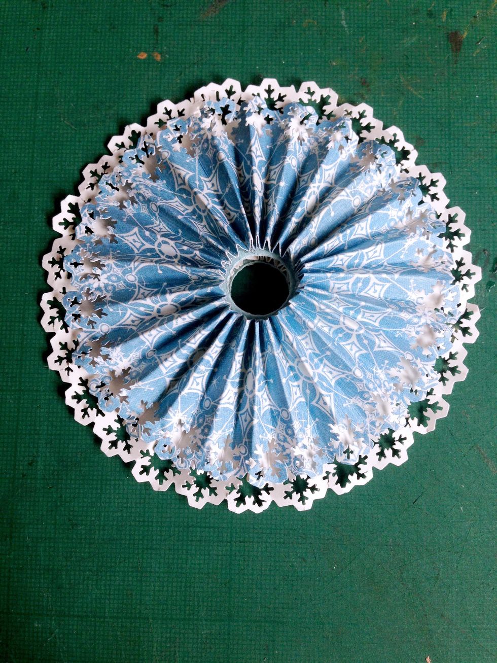 Flatten down the Snowflake Waltz rosette and glue on top of the white rosette, forming a dual layer of rosettes... You may need to hold down the rosette to prevent spreading...