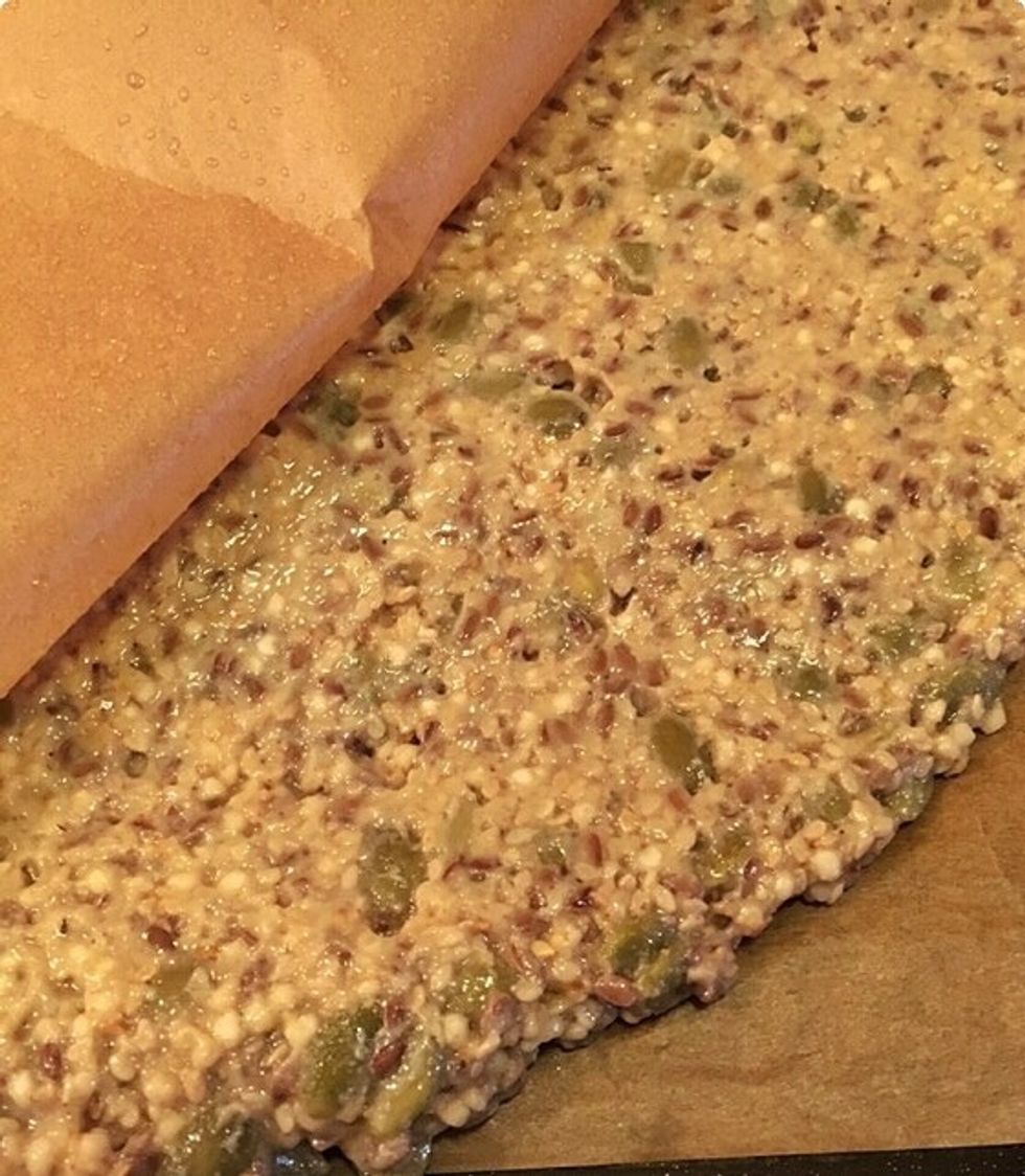 Flatten it out by adding another parchment paper on top. The trick is here to not make it too thin or it will crumble once it is done simply by looking at it.