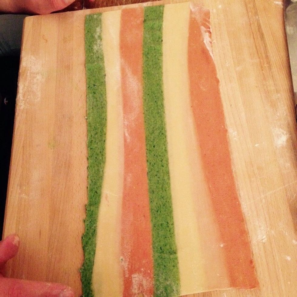 Flatten it out using the pasta machine and avoiding folding the pasta on itself as much as possible.