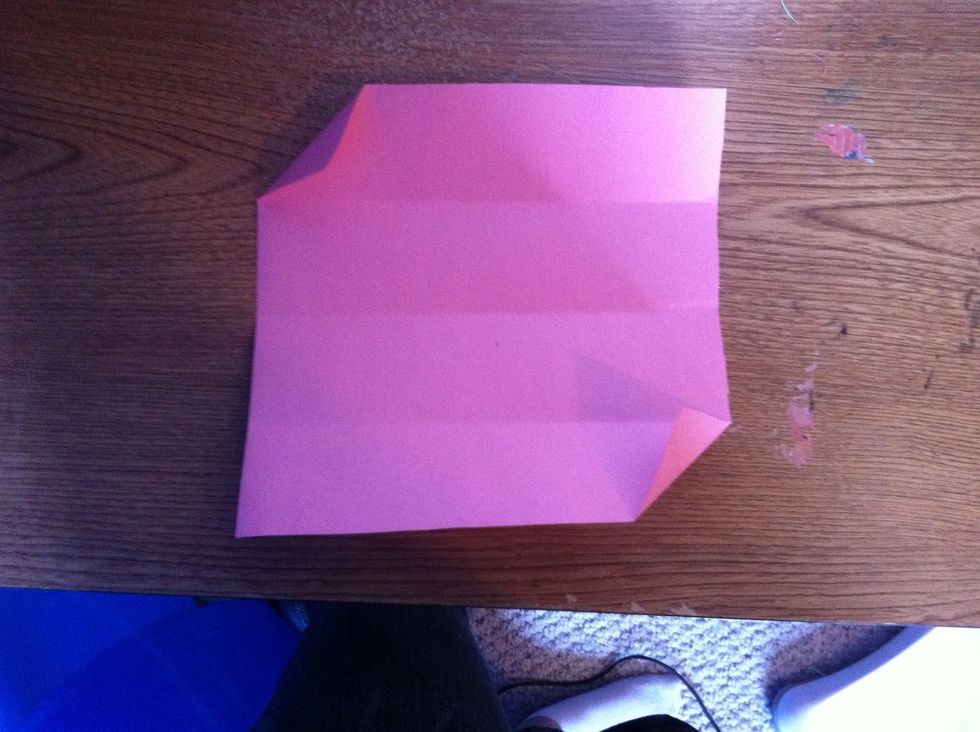 Flatten it out with the corners still folded.