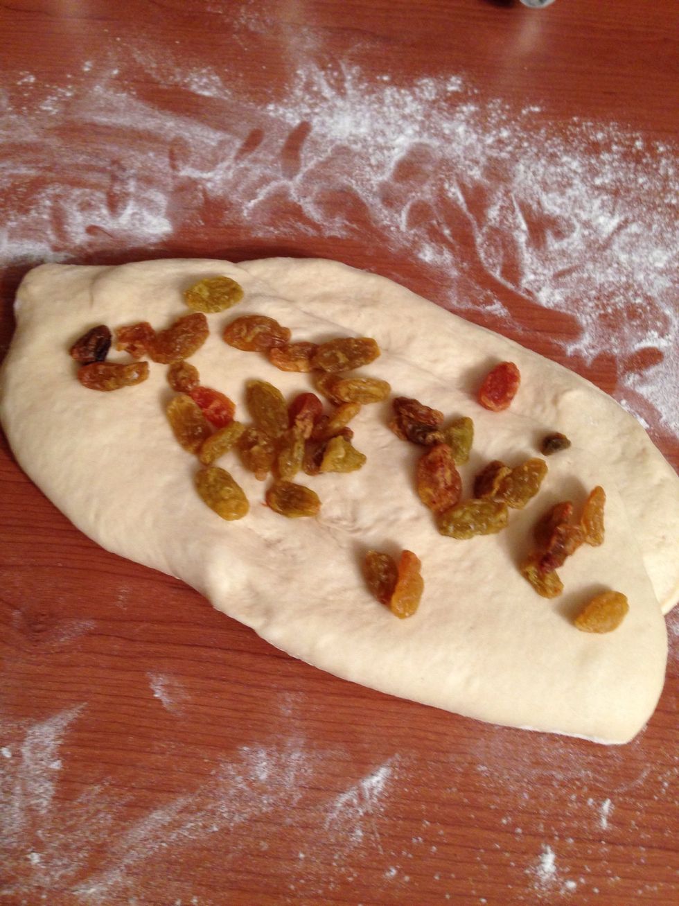 Flatten one part and add 1/4 c golden raisins