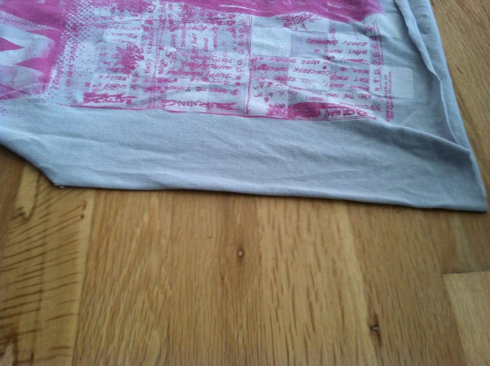 Flatten one side of shirt so it is even to the shoulders.