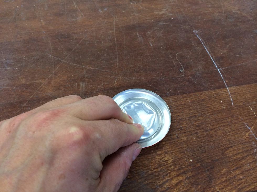 Flatten out the bottom of the can carefully by pressing down firmly bit by bit.