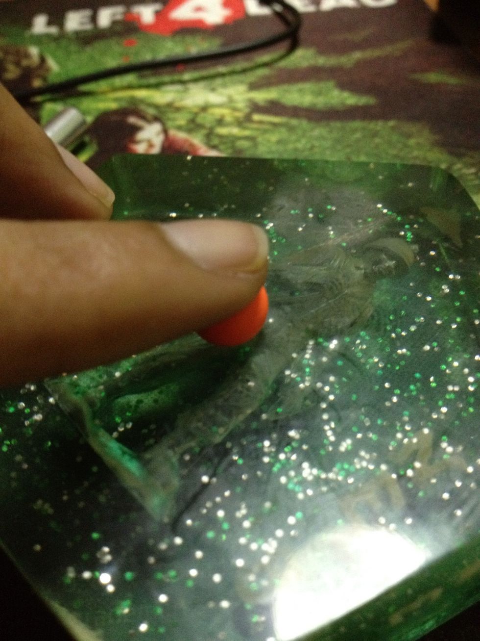 Flatten the ball, but not all the way, to the shape of a regular M&M.