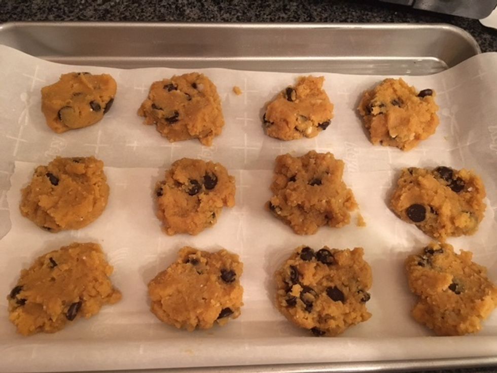 Flatten the balls of dough using the back of a spoon