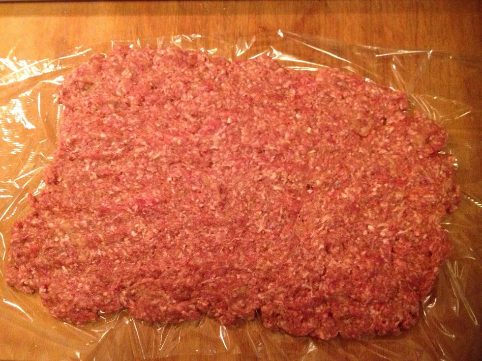 Flatten the ground beef onto plastic.