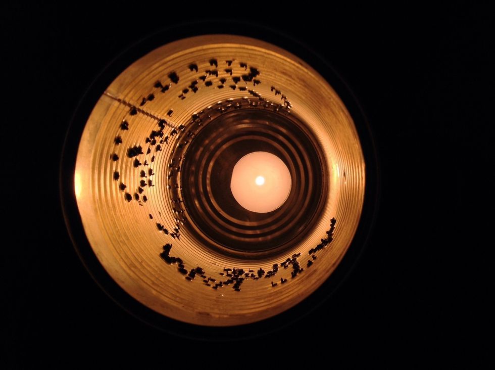 Flatten the pointed edges using a file tool. A candle will be put inside the tin can.