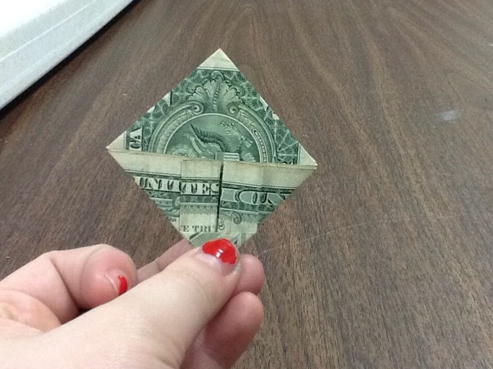 Flatten the section you've just folded, and still try and keep a straight line. The corner below might rip if you're not careful, so be sure to fold that part in as well. Crease it with your nails.