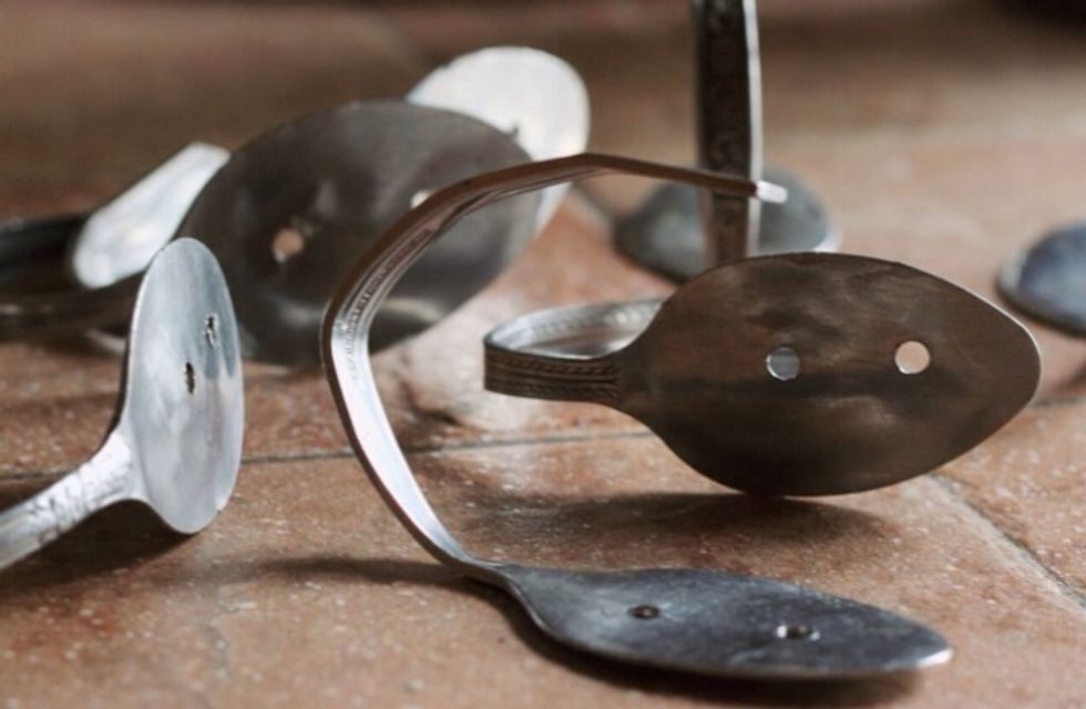 Flatten two or more spoons and drill in two holes. Bend the handle into a hook.