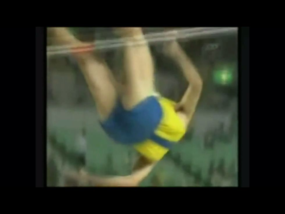 Flick your legs up to 'recover' them over the bar. This helps round your back ready for landing on your shoulders.